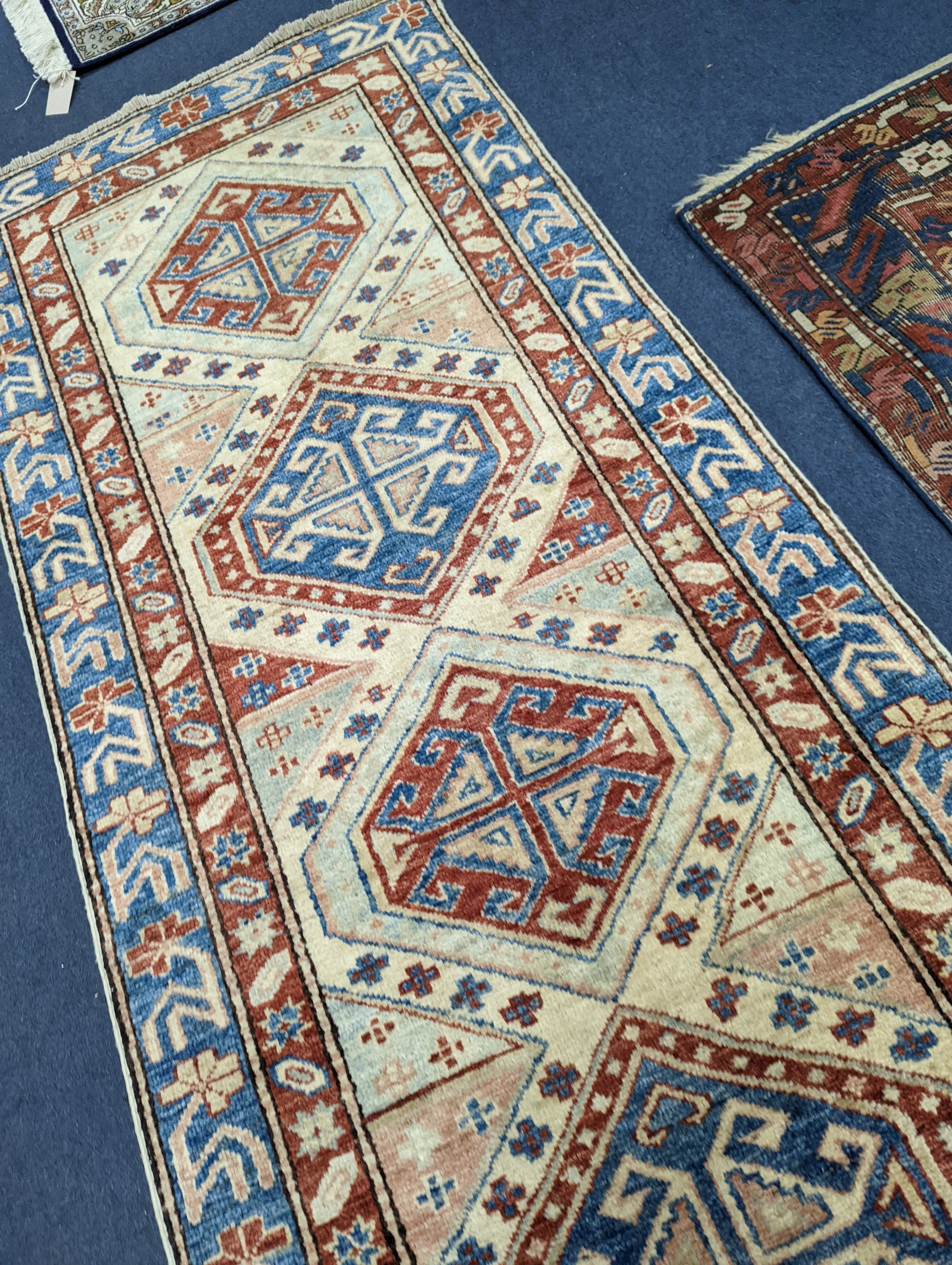 A Caucasian design ivory ground runner, 280 x 70cm